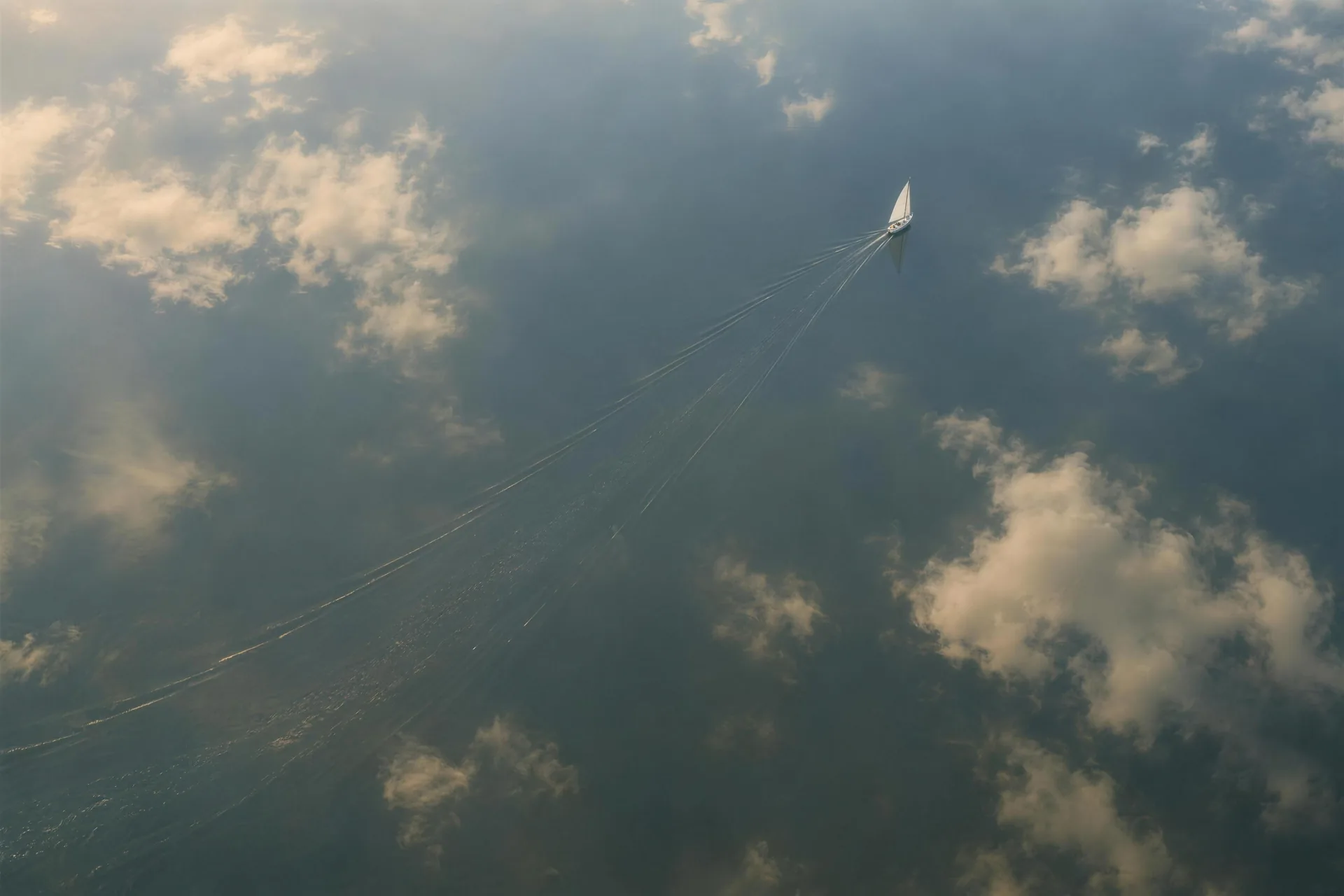 An overhead view of a sailboat on the open sea.